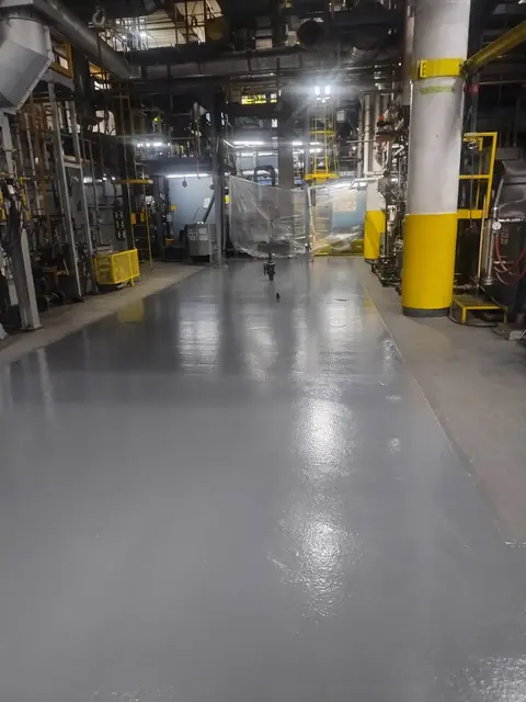 Seamless gray epoxy floor in an industrial plant